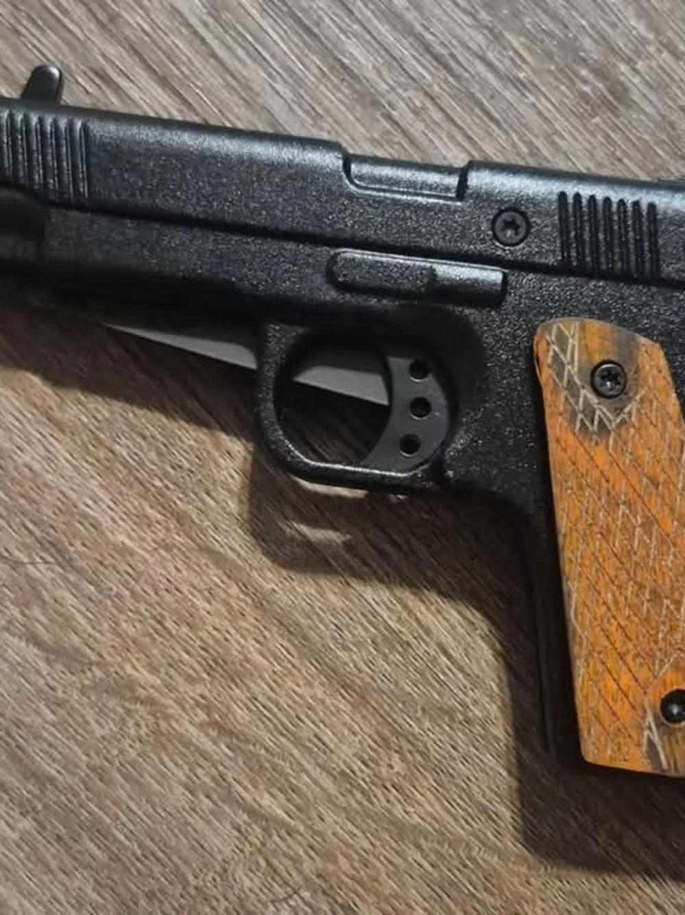 Black Handgun with Wood Grip Accent